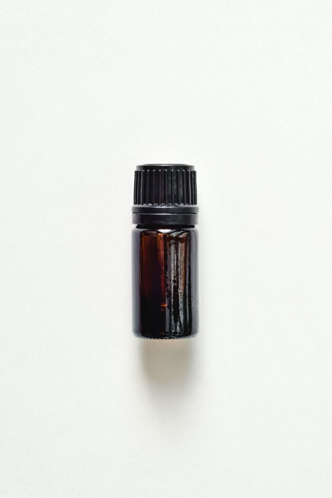 close up shot of small bottle on white surface