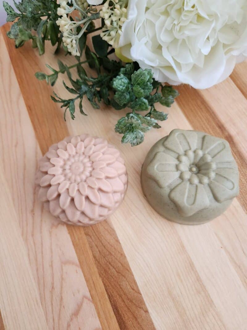 handmade floral soaps on wooden table
