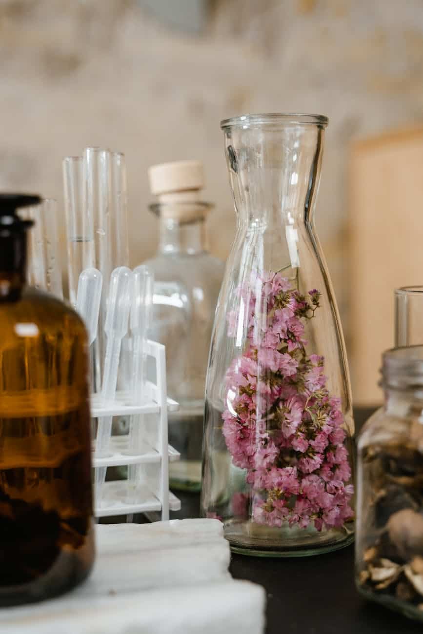 clear glass bottles on white wooden shelf
